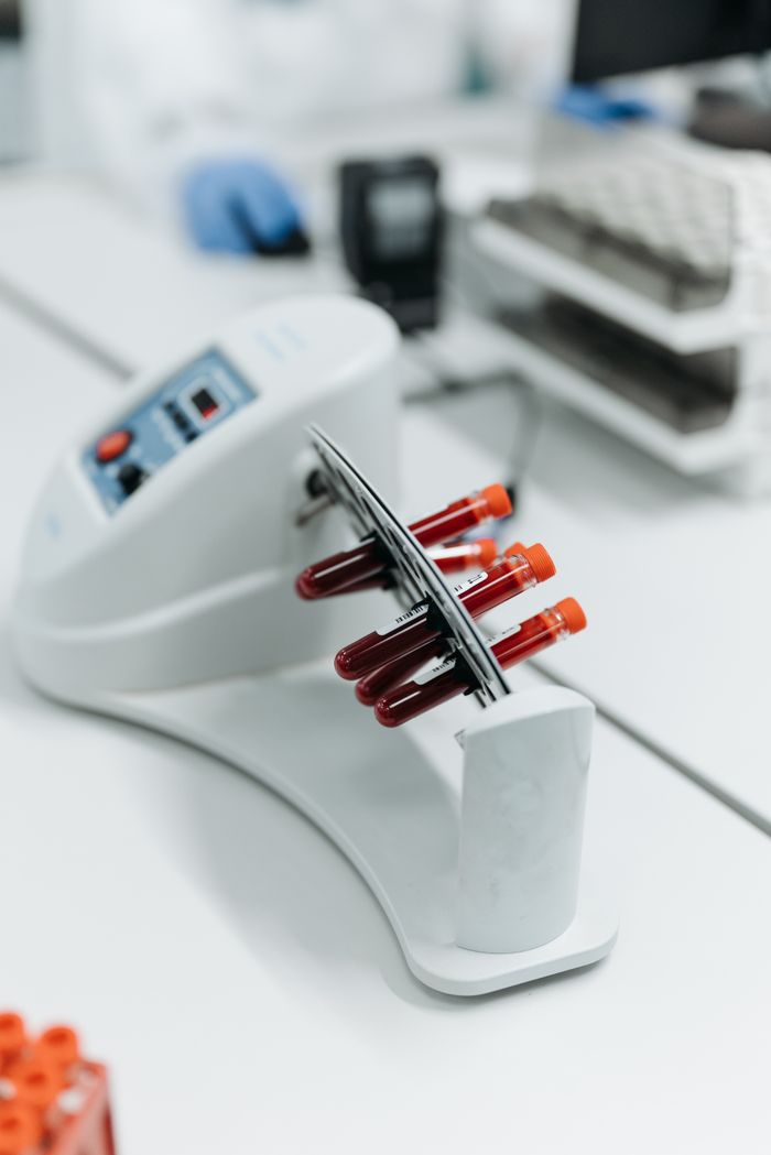 Menu Close-up of a laboratory centrifuge holding blood samples in test tubes.